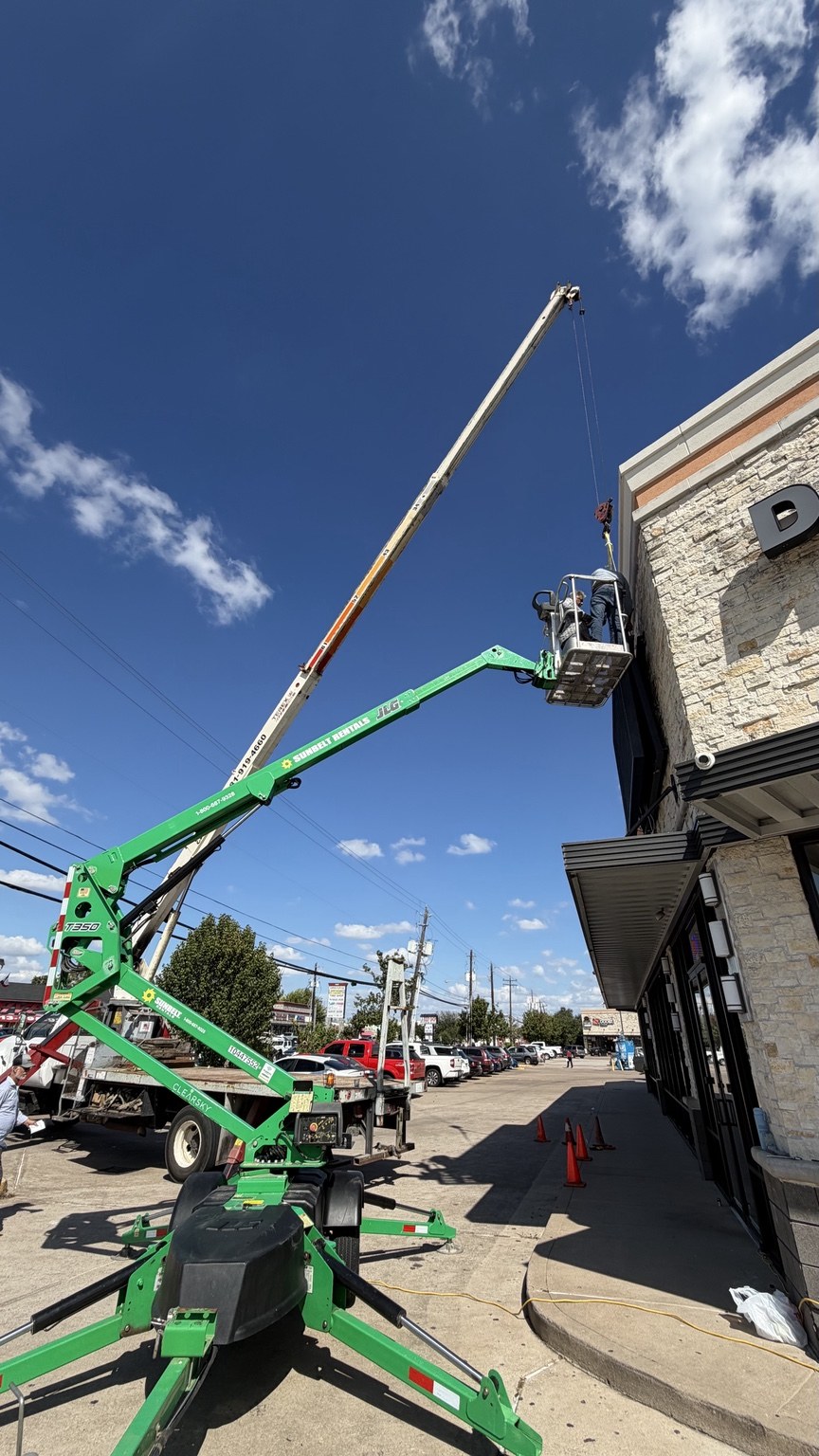 Crane and lift during exterior display installation